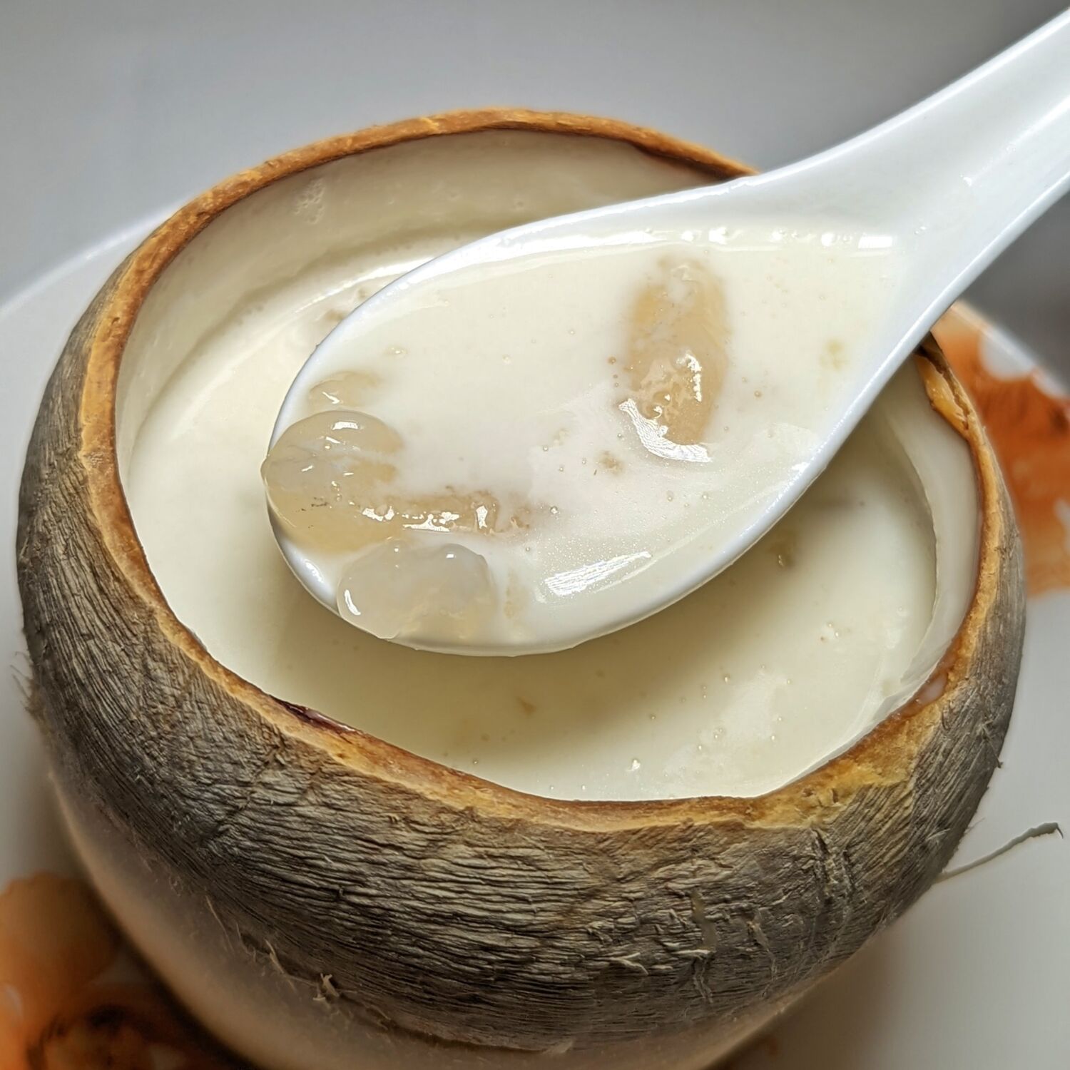 Regent Singapore Summer Palace Double-boiled Hasma with Almond Cream served in Young Coconut